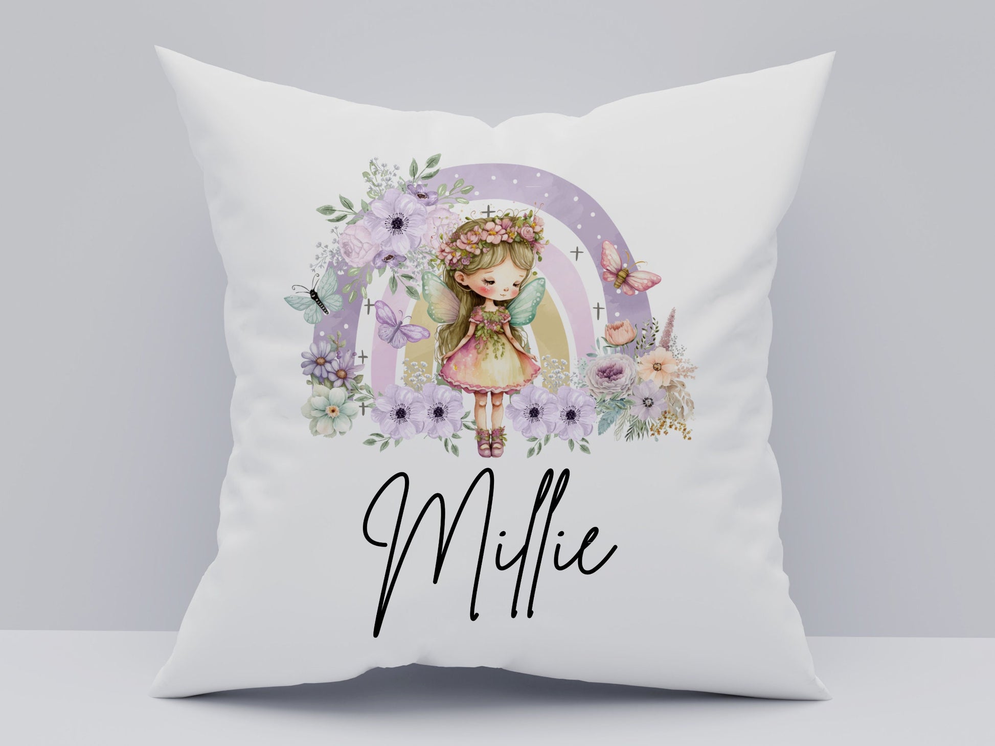 White pillow with a cartoon girl and floral design, featuring the name 'Millie'.