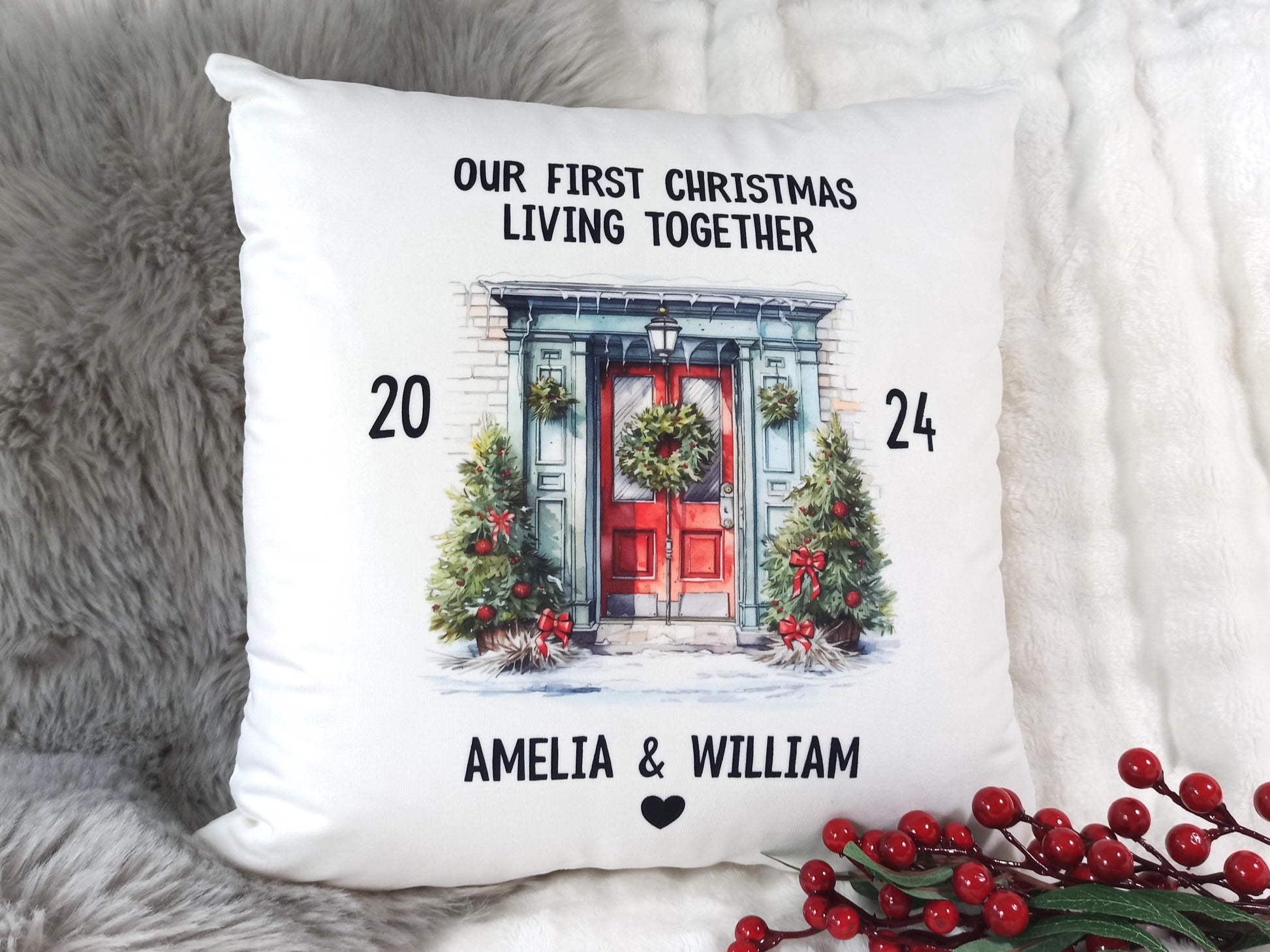 Decorative pillow with Christmas design and text 'Our First Christmas Living Together' on a soft surface.