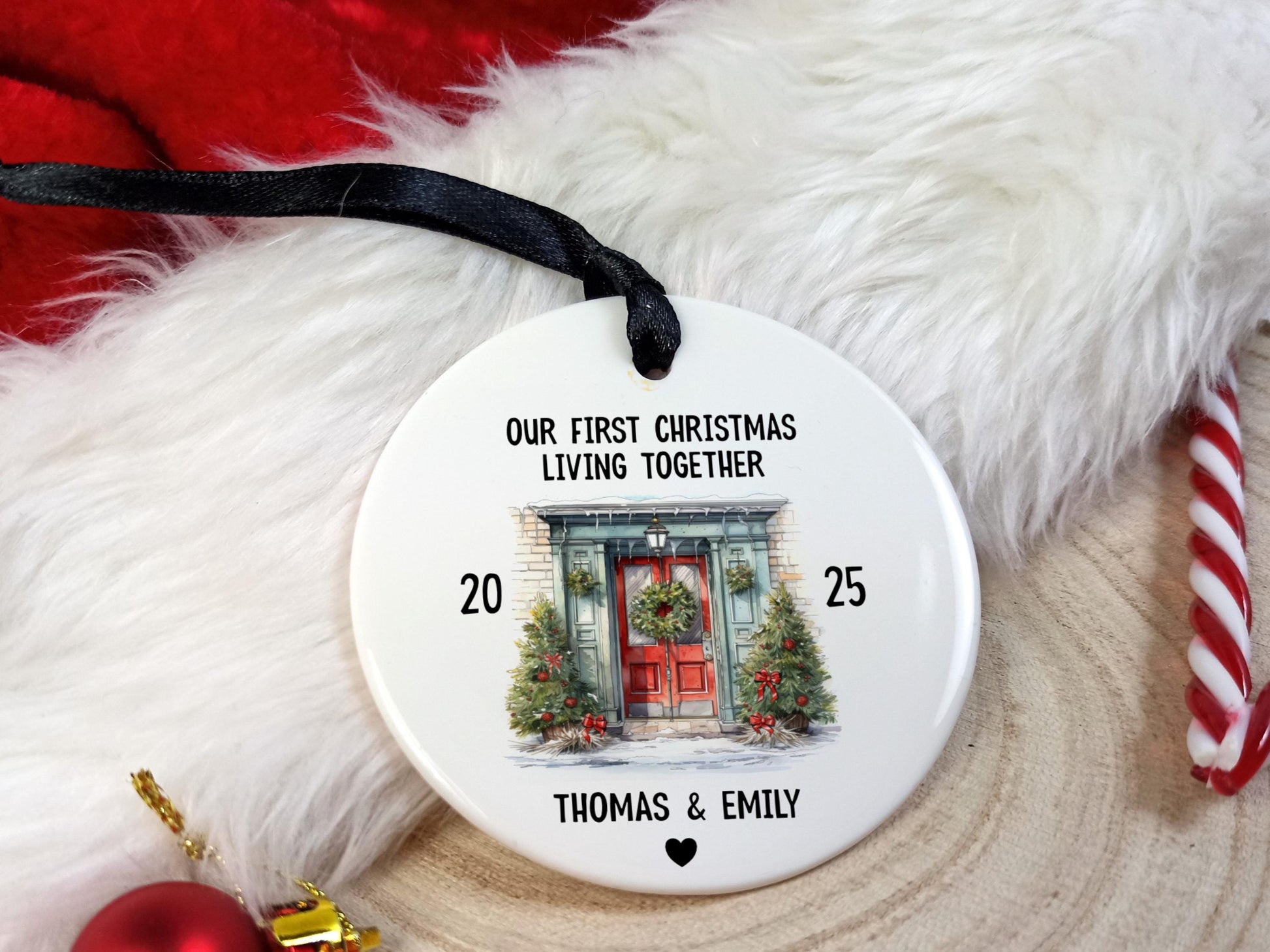 Christmas ornament with 'Our First Christmas Living Together' text and a door illustration, placed on a festive background.